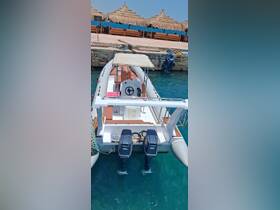 A sleek speedboat docked at a marina, showcasing its modern design and powerful twin engines — perfect for thrilling water adventures.