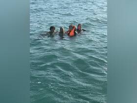 A group of friends enjoys a refreshing swim in the ocean, showcasing the fun and adventure of water activities.