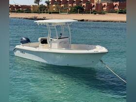 A sleek center console boat docked in clear turquoise waters, showcasing its elegant design and perfect for day trips on the water.