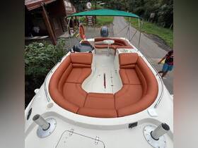 A spacious interior view of a boat featuring comfortable seating, perfect for relaxing during a day on the water.