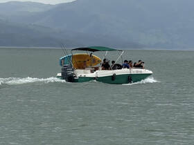 A lively group enjoys a day on the water aboard a boat, showcasing the fun and camaraderie of on-water activities.