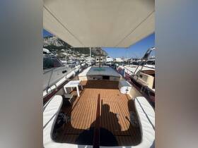 Interior view of a boat's helm area showcasing polished wooden flooring and comfortable seating, perfect for relaxing while enjoying the marina scenery.