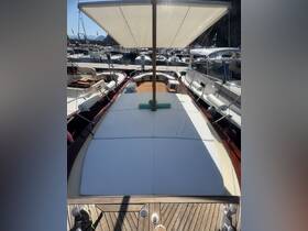 A spacious and shaded seating area inside a boat, perfect for relaxation and enjoying the views while docked.