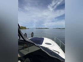 A serene view from the front of a yacht, showcasing the calm waters and distant islands, perfect for a relaxing day on the water.