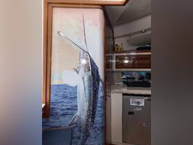 Interior view of a boat featuring a striking mural of a marlin, showcasing the vessel's fishing theme and amenities.