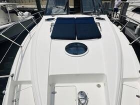 A view of the spacious seating area on the deck of a boat, perfect for lounging and enjoying the sun. A person is visible in the background, adding to the ambiance of a relaxing day on the water.