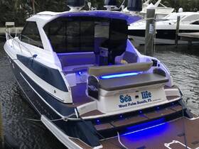 A sleek yacht named 'Sea Life' docked in West Palm Beach, showcasing its elegant design and inviting seating area, perfect for luxurious outings on the water.
