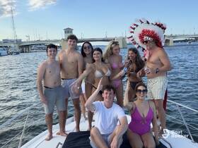 A lively group of friends celebrates on a boat, enjoying drinks and the sun — perfect for summer parties and memorable outings on the water.