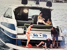 A lively group enjoys a fun day on a boat in West Palm Beach, with activities and laughter creating a perfect party atmosphere on the water.