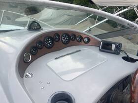 A detailed view of the helm console on a boat, showcasing various gauges and a navigation device, perfect for understanding the vessel's controls and features.