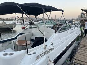 A sleek Four Winns boat docked, showcasing its elegant design and comfortable seating, perfect for leisurely outings on the water.