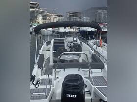Interior view of a sleek boat helm featuring comfortable seating and modern controls, perfect for navigating the waters in style.