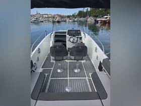 A well-equipped helm area of a Jeanneau boat featuring comfortable seating and modern controls, perfect for navigating the waters.