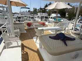 A spacious and inviting interior of a boat featuring comfortable seating and a lounge area, perfect for relaxing while enjoying the marina views.