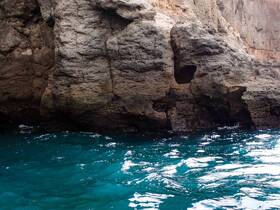 A close-up view of rocky cliffs above turquoise waters, but the image lacks clarity and identifiable features.