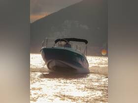 A sleek speedboat navigates through shimmering waters, showcasing its dynamic design against a stunning sunset backdrop.