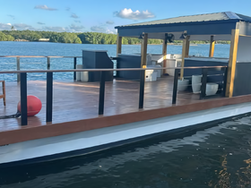 Interior view of a spacious boat cabin featuring seating and amenities, perfect for comfortable outings on the water.