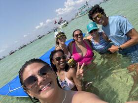 A joyful group of friends enjoys a sunny day in the water, capturing memories with smiles and laughter — perfect for summer beach outings.
