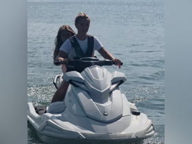 Two young riders enjoy a thrilling jet ski adventure on the water, perfect for summer fun and water sports enthusiasts.