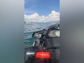 A dynamic view from a jet ski, showcasing the excitement of on-water activities against a backdrop of scenic clouds and water.