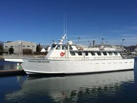 A pristine view of the 'Nantucket Sound' yacht docked at the marina, showcasing its sleek design against a clear blue sky.