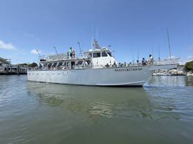 The Nantucket Sound boat is seen with a lively group of people on board, ready for a day of fishing and adventure. Perfect for exploring the waters and enjoying time with friends and family.