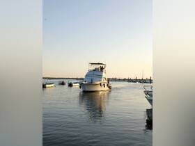 A yacht navigates through calm waters at sunset, showcasing a serene boating experience perfect for evening cruises.