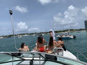 A lively group enjoys a day on the water, celebrating aboard a boat with friends — perfect for summer outings and memorable adventures.