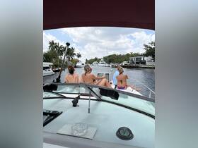 A group of friends relaxes on the deck of a boat while cruising through a scenic waterway, enjoying the beautiful surroundings and each other's company.