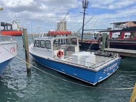 A blue boat named 'Starfish' is docked at the marina, showcasing its structure and surroundings, perfect for fishing or sightseeing tours.