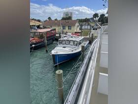 A docked boat named 'STARRISH' is showcased in a marina setting, surrounded by other vessels and waterfront buildings, ideal for exploring local waters.