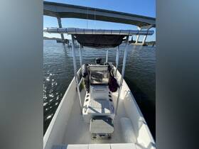 Interior view of a boat's helm and seating area, showcasing the console and storage options — perfect for a day out on the water.