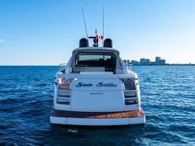 A stunning view of the back of the 'Sea Suite' yacht, showcasing its elegant design against a clear blue sky and tranquil waters, perfect for luxury boating experiences.