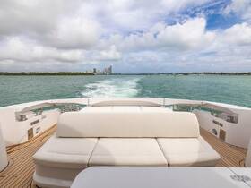 A cozy seating area inside a luxury yacht, perfect for relaxing while enjoying scenic views of the water and skyline.