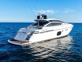 A stunning view of a luxurious yacht cruising through clear blue waters, showcasing its sleek design and elegance on the open sea.