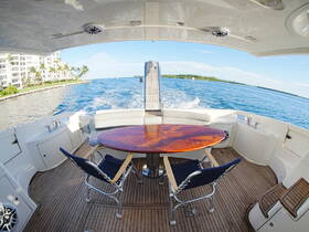 A beautifully designed interior space of a boat featuring a polished dining table and comfortable seating, perfect for enjoying meals while cruising on the water.