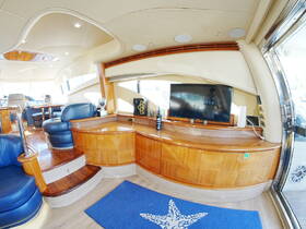 Interior view of a luxurious boat cabin featuring comfortable seating and modern amenities, perfect for relaxing while cruising on the water.