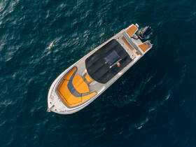 Aerial view of a sleek speedboat showcasing its vibrant orange seating and modern design, perfect for thrilling adventures on the water.