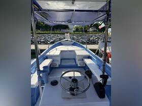 A clean and spacious helm area of a boat, featuring comfortable seating and essential controls, perfect for navigating the waters.