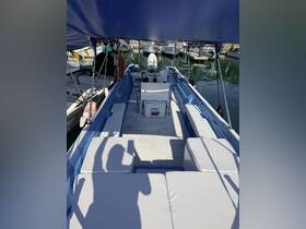Interior view of a boat showcasing comfortable seating and helm area, perfect for relaxing and navigating on the water.