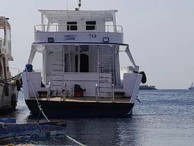 A clear view of a boat docked at the marina, showcasing its structure and design — ideal for exploring local waters or chartering adventures.