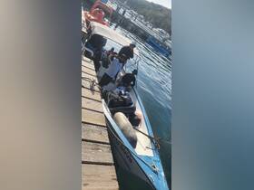 A lively group enjoys their time aboard a boat at the dock, capturing fun moments before heading out on an adventure.