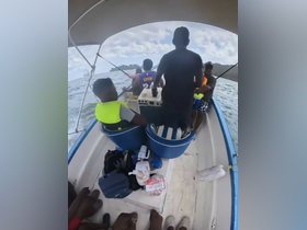 A group of individuals enjoy a boat ride, showcasing the excitement of on-water adventures. Perfect for family outings or group excursions.