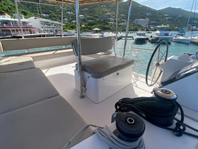 Interior view of a yacht's helm and seating area, showcasing a comfortable space for relaxation and navigation while enjoying the beautiful surroundings.