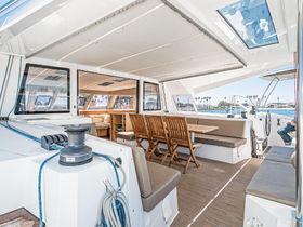 A spacious interior view of a boat featuring comfortable seating and a helm, perfect for relaxing and enjoying the journey on the water.