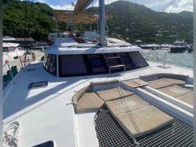Interior view of a spacious catamaran lounge area featuring comfortable seating, perfect for relaxation while enjoying the beautiful surroundings.