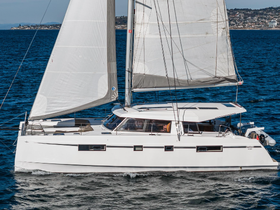 A sleek catamaran sails gracefully through the water, showcasing its elegant design and spacious layout, perfect for leisurely cruises.