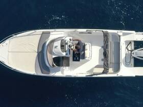 Aerial view of a center console boat with a person at the helm, navigating through deep blue waters — perfect for exploring coastal destinations.