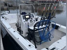 The interior of a fishing boat showcasing the helm and fishing gear, ideal for anglers looking to enjoy a day on the water.