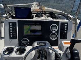 A detailed view of the helm and console of a Robalo boat, showcasing navigation equipment and controls, perfect for boating enthusiasts and those interested in marine technology.